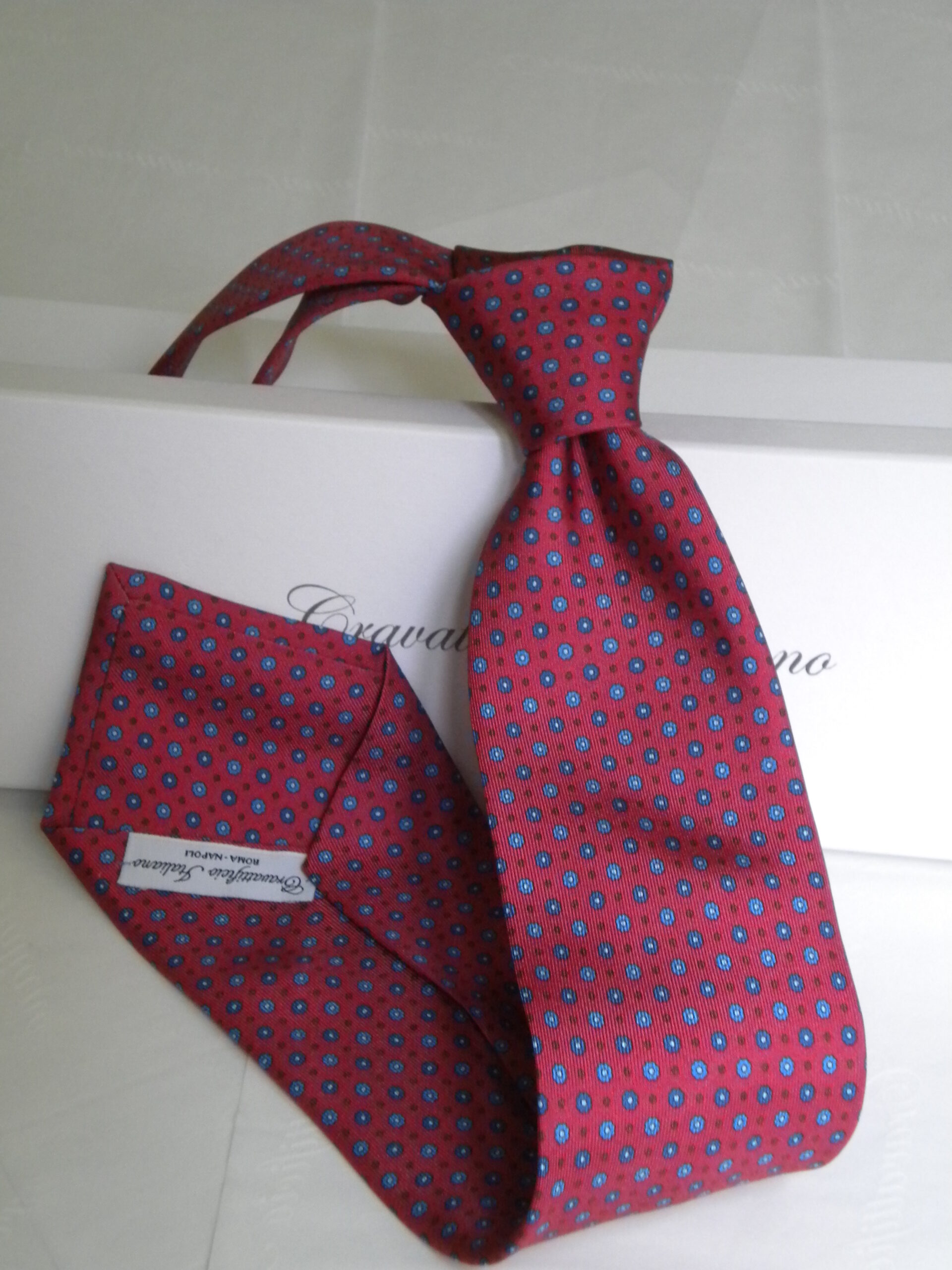 Red tie coordinated with packaging for corporate supplies